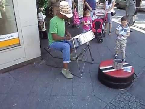 Street artist playing steelpan in Berlin Neukoelln.
