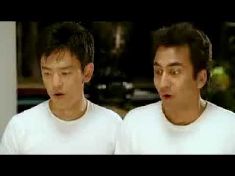 Green-band trailer frame for Harold & Kumar Escape from Guantanamo Bay (2008) showing the leads in orange jumpsuits behind wire fencing