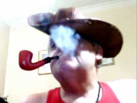 Cowboy, with Red TShirt of Surf, Smoker, of Red Paronelli, Pipe Tobaccos, Curved; in Summer.