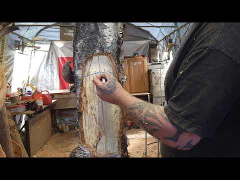 live carving a woodspirit with chainsaw.