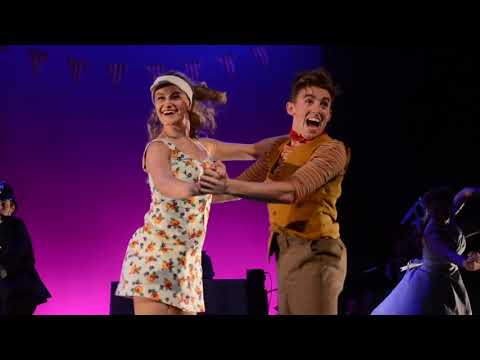 Trailer still — finale tableau with Minnie center-stage and confetti, chorus mid-cadence
