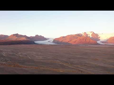 Fall colors surround glacial mountains in Iceland.