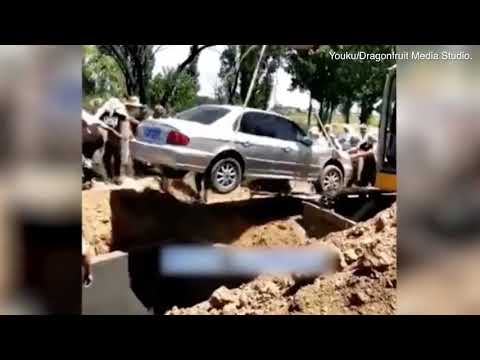Bizarre moment a deceased man is buried in a car in China