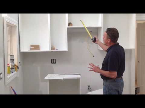 Part of a video titled How to assemble & install IKEA Sektion wall cabinet - YouTube