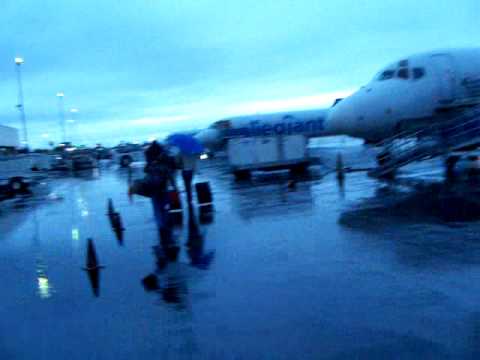 Boarding an MD82 outside next to the BLUE MAN in the rain