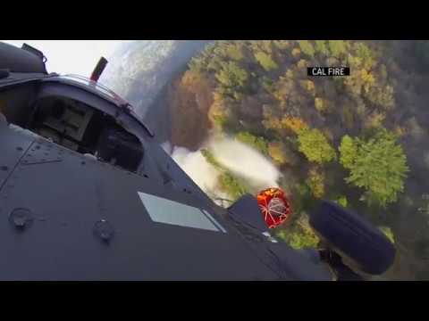 The National Guard aids in fighting the historically devastating fire in northern California, dropping water on the flames in Butte County (Nov. 15)