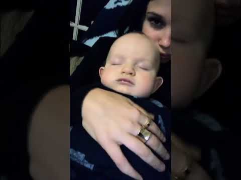 Millie Bobby Brown snuggling a baby