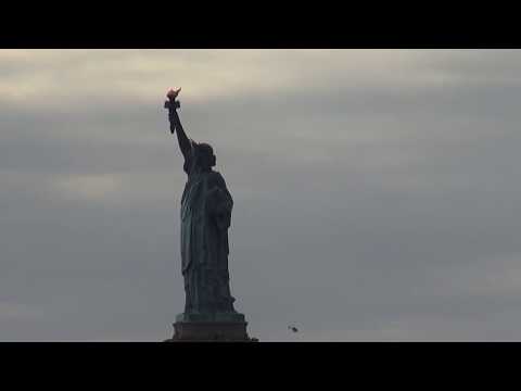 statue of liberty and tourists