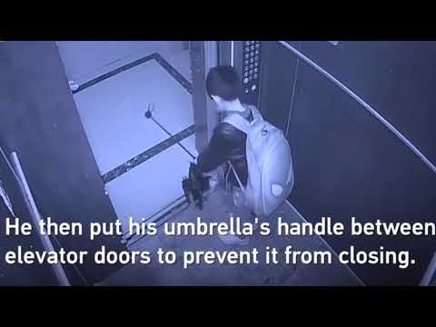 Boy uses umbrella to prevent elevator door from closing causes free fall