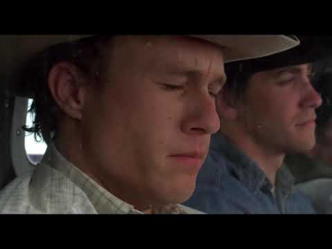 Trailer still: nighttime campfire glow with muted guitar theme implied