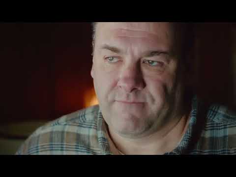 Official trailer frame — suburban Jersey teens staring at a TV playing the Rolling Stones