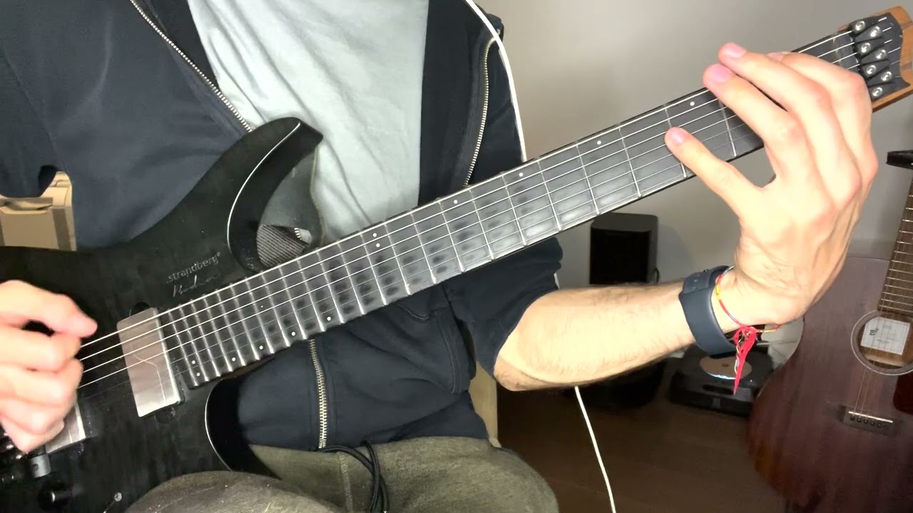 Guitarist playing a hybrid picking riff from Atomic Symphony's Nightfall on electric guitar