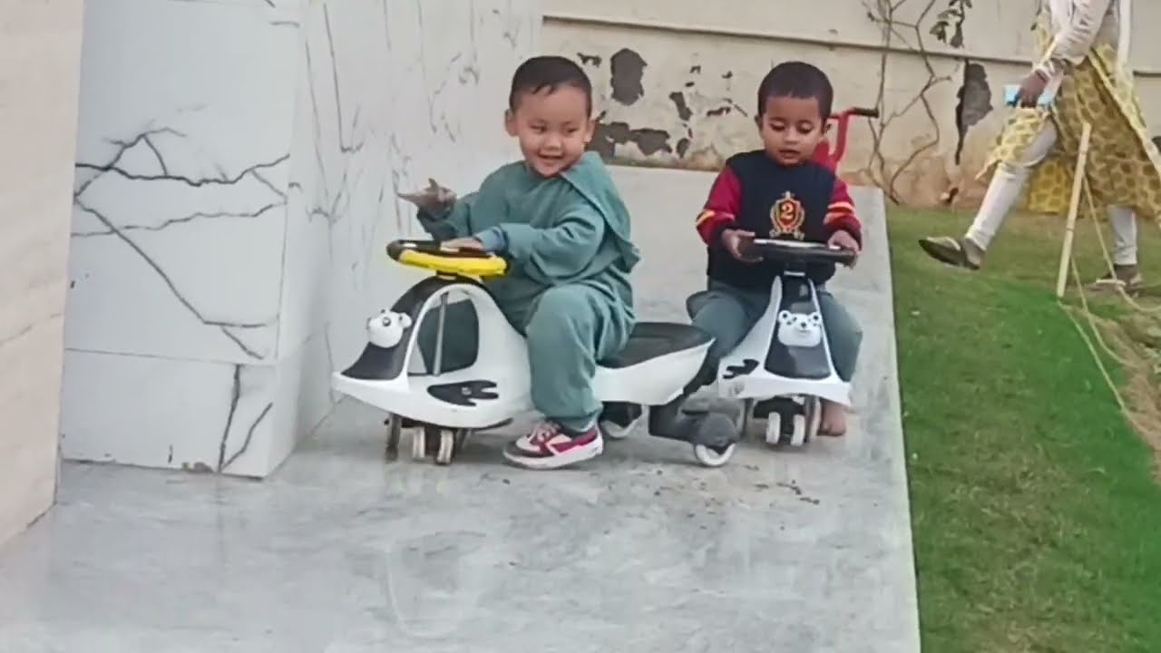 Toddlers on perimeter track demonstrating gross motor skill development