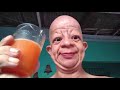 bald guy drinks orange juice