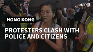 Hong Kong police make arrests as 'flashmob' protests hit pro-Beijing targets | AFP
