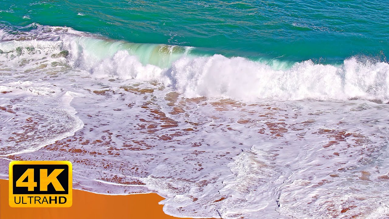Foamy waves kissing a sandy beach // The Great Ocean Road