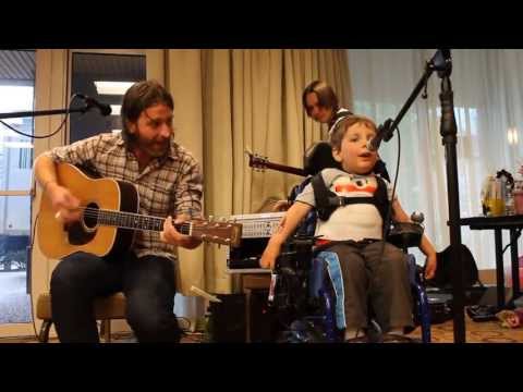 Music therapist plays a song with one of his clients.