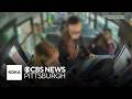 Students leap into action after noticing bus driver limp over steering wheel