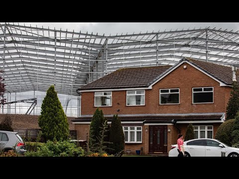 "It's like a cruise ship in our garden": New 60ft warehouses loom over homes | SWNS