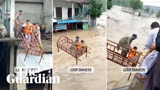 Pakistan flood victims rescued on bed frame pulled over raging waters