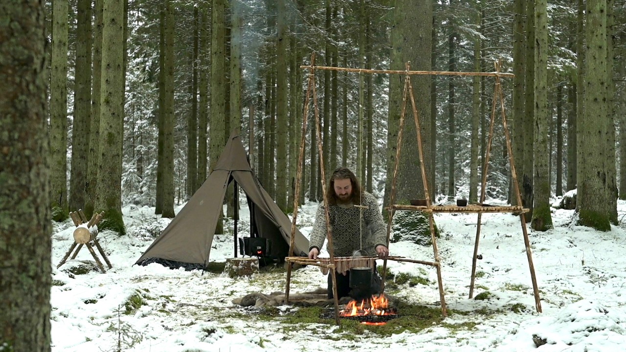 Solo winter bushcraft trip - canvas tent, wood stove, saw horse, cooking tripod, homemade axe etc.