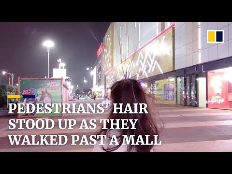 Pedestrians’ hair stood on end as they walked past a mall in China