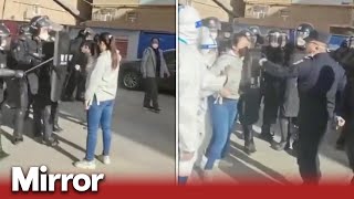 China: Defiant woman stands up to police during protest