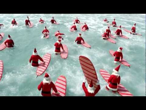 ⁣Surfing Santa