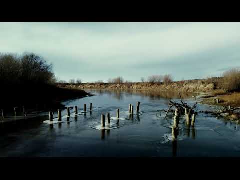 The first autumn ice on the Siberian river  Drone video in 4K