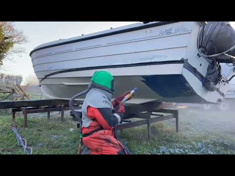 Sodablasting paint off a boat hull. This is the most cost effective way to strip paint.