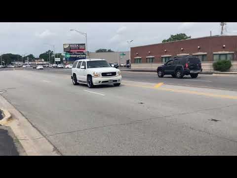 This GMC Yukon Denali has a custom exhaust system, dual exhaust tips, and a set of custom rims.