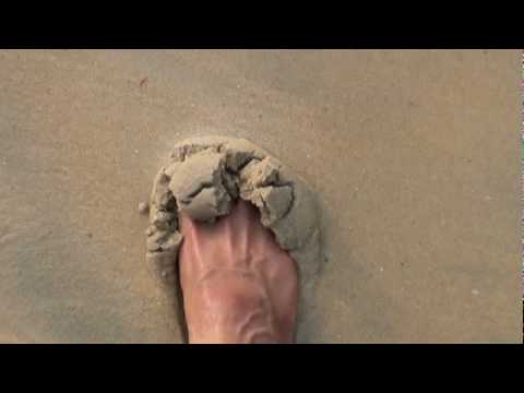 My foot playing with sand and surf