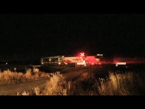 Passenger and Freight Train at a Level Crossing at Night - Australian Trains at Railroad Crossing