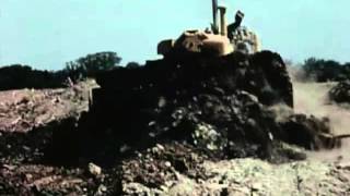 The famous Caterpillar bulldozer blade was introduced in 1945. Here's a clip from an instructional video about bulldozing.