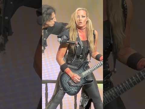 Nita Strauss tearing it up while Alice Cooper watches like a proud villain.