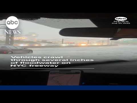 Vehicles crawl through several inches of floodwater on NYC freeway