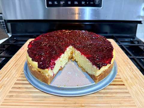 White Chocolate Lemon Cheesecake with Biscoff Cookie Crust and Mixed Berry Compote