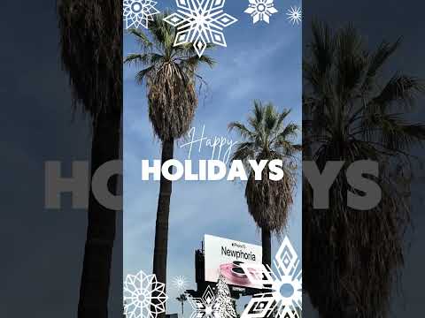 Twin palms rise like nature’s own festive pillars, framing the LA skyline with their holiday cheer