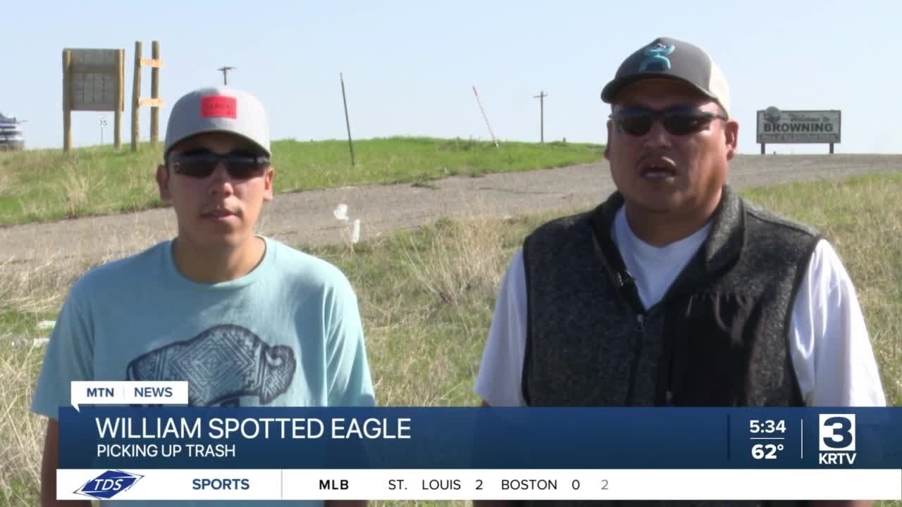 Father and son picking up trash in Browning