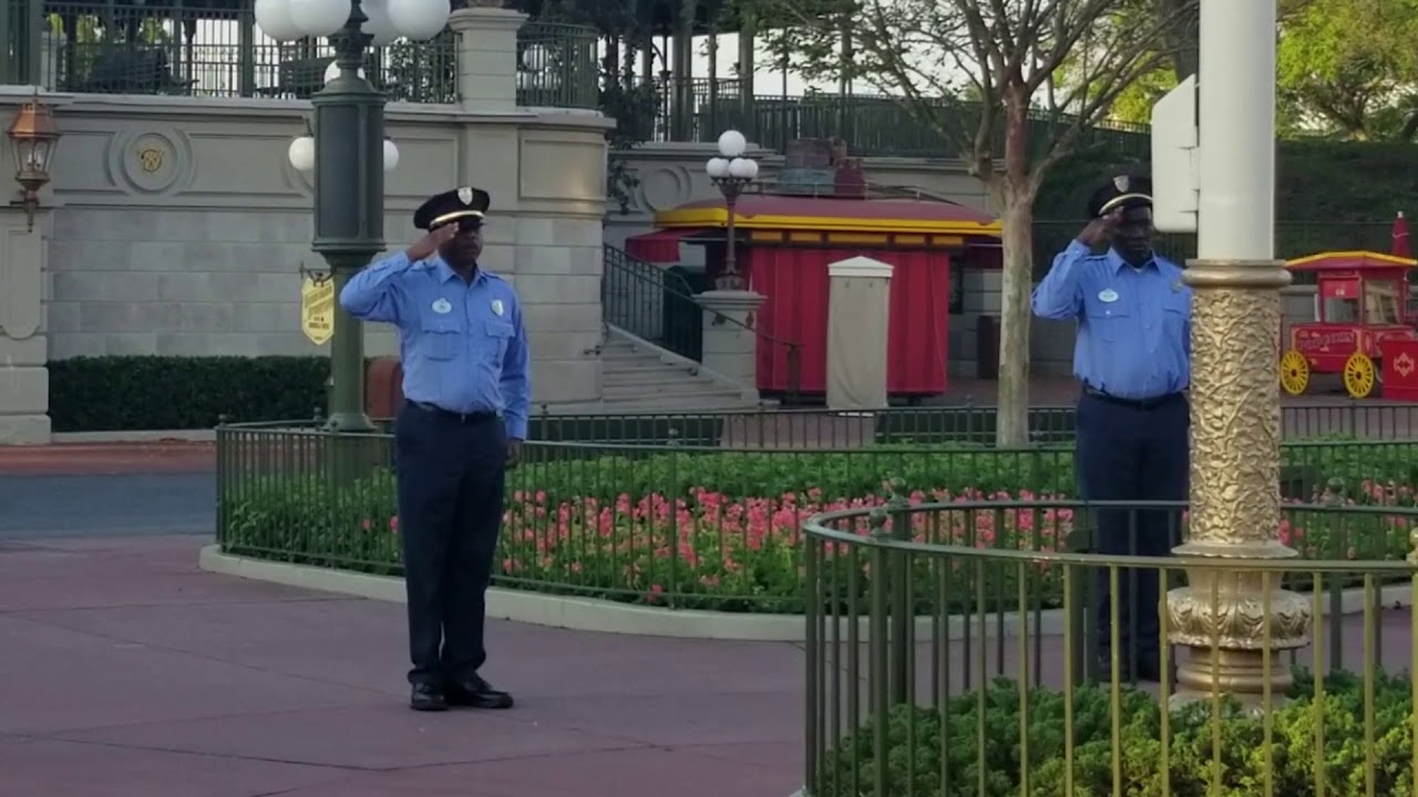 Raising the flag at a closed Magic Kingdom due to COVID-19