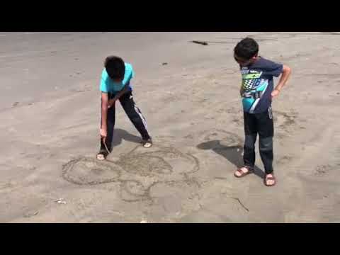 Kids sand drawings on the beach
