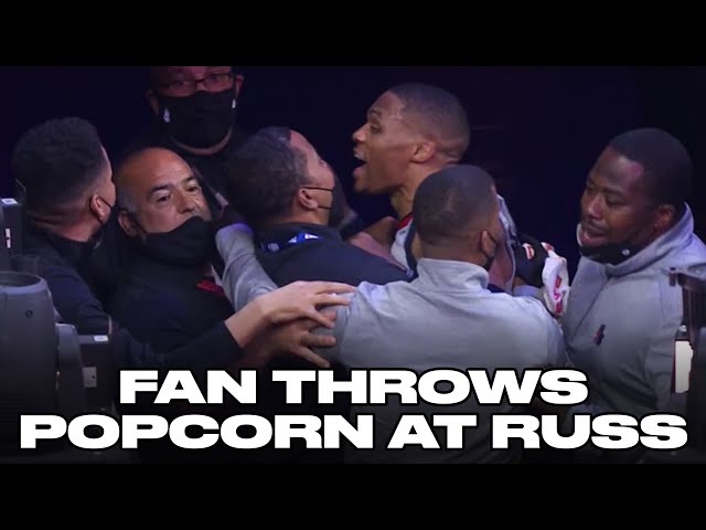 Russell Westbrook restrained after popcorn thrown on his head