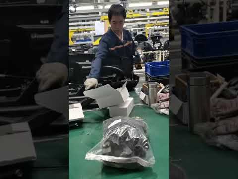 Auto parts factory workers assemble auto parts like this