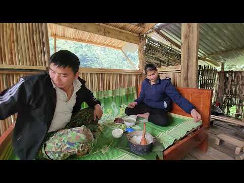 The couple enjoys a warm and happy meal together in their thatched cottage.