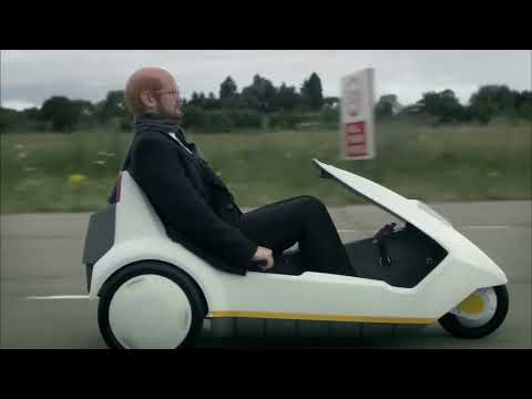 Sir Clive Sinclair in his C5 is overtaken by HP and Microsoft.  Alexander Armstrong in Micro Men.