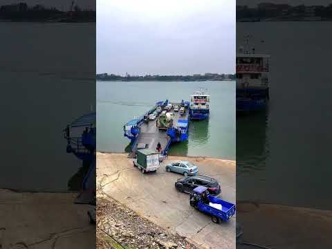A mixer truck crosses the river by boat to record real life. Crossing the river by ferry. Beautiful