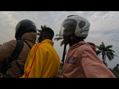 Riding past Binkolo,Sierra Leone on their Luma sales day.