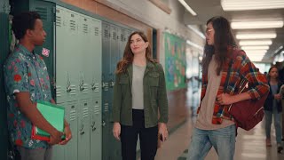  Woman tries to reach the height of students