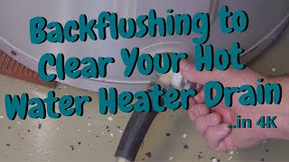 Back-flushing a clogged drain on a hot water heater