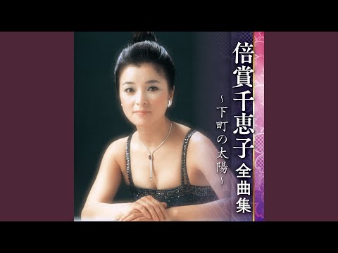 雪の降る街を